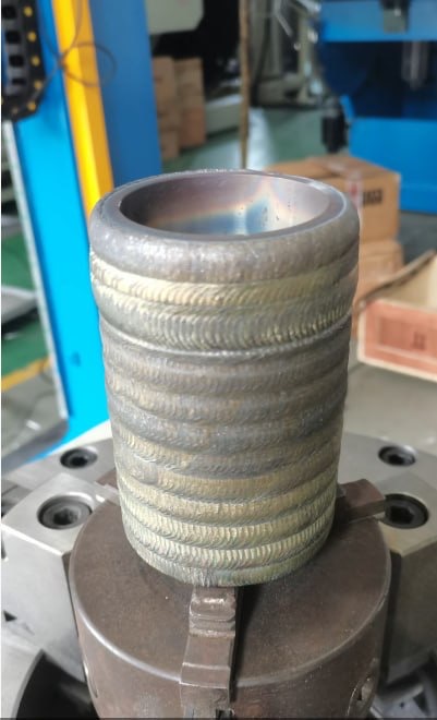 Sleeve after welded hardfacing overlay before final machining